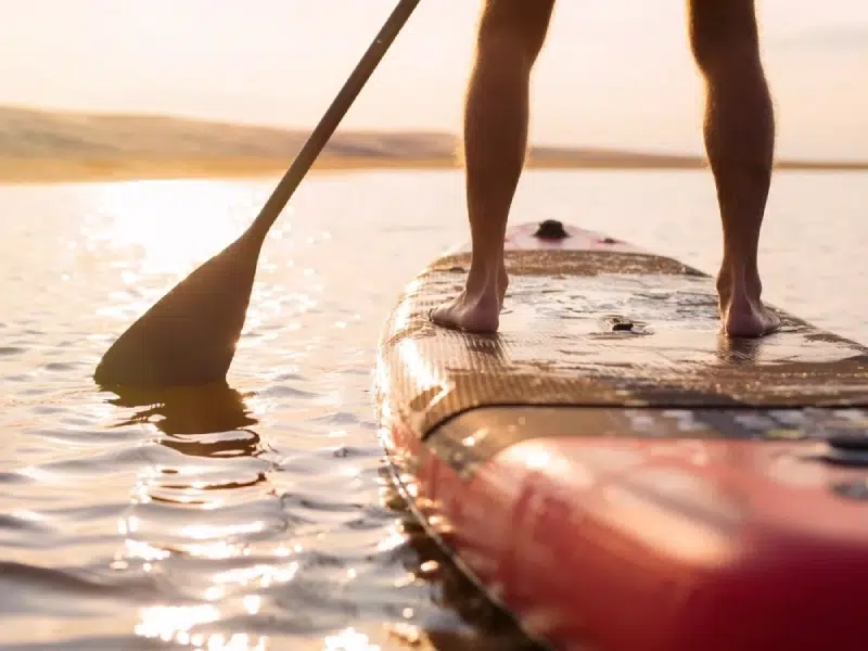 Personne pratiquant le paddle sur une mer calme près du camping Granville bord de mer
